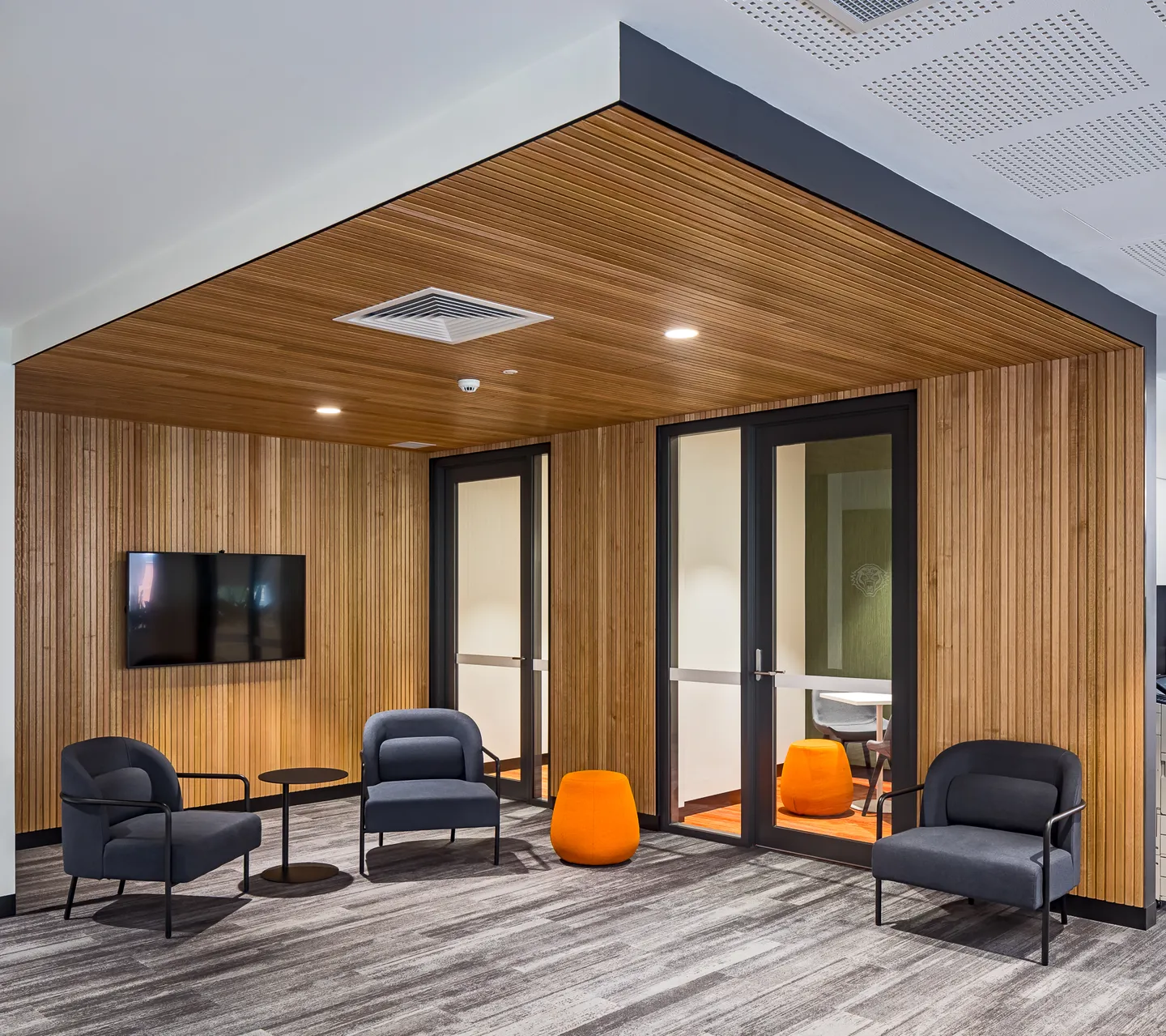Timber-lined meeting room and lounge seating — West Tigers Centre of Excellence