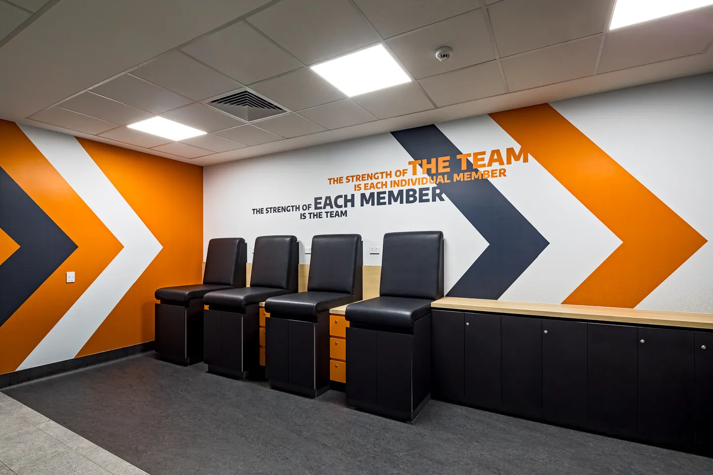 Team seating with storage joinery and Tigers wall graphics — West Tigers Centre of Excellence